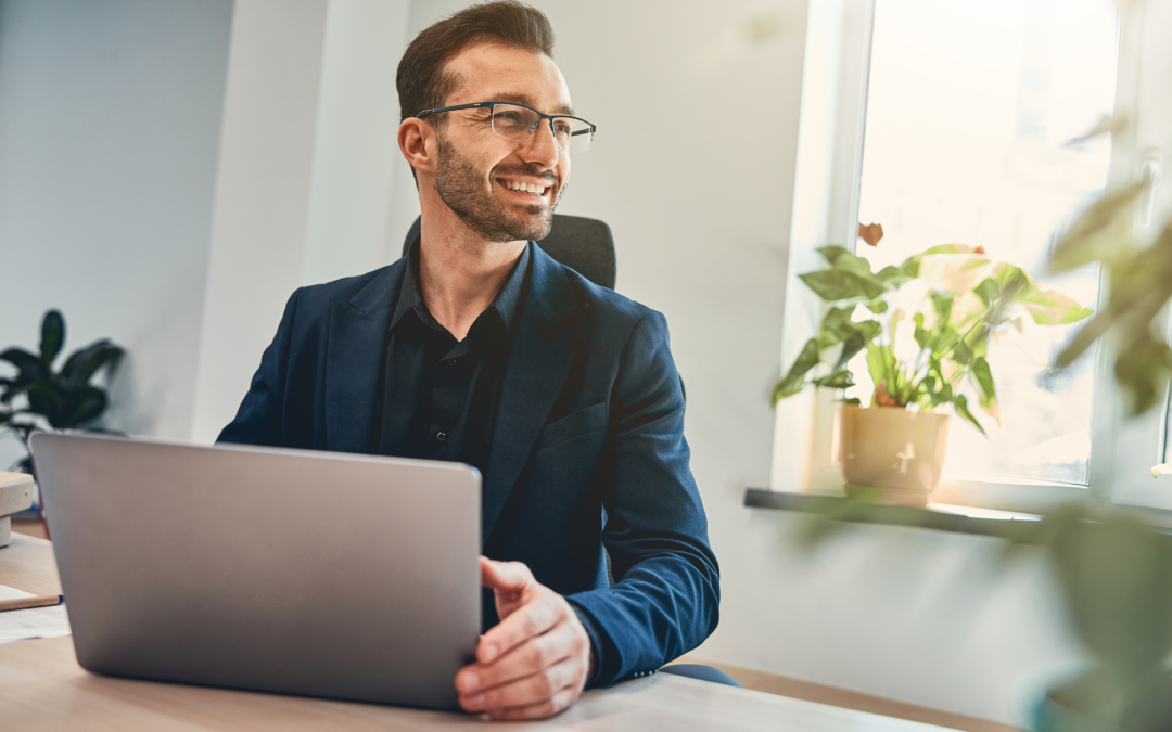 An image showing a project manager with a laptop in front of him,